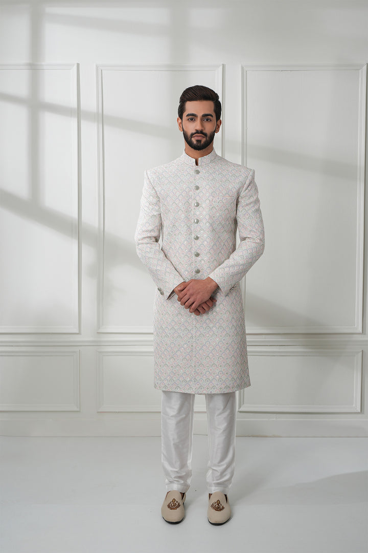 Featuring A White Sherwani In Chikankari Base With Embroidery